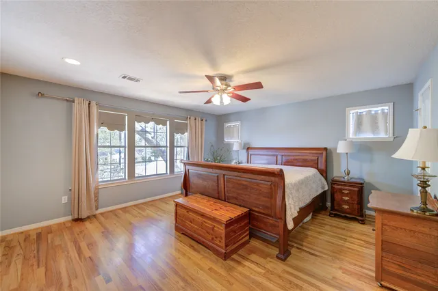 a bedroom with a bed and wooden floor