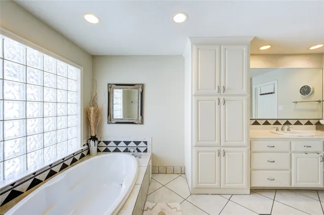 a bathroom with a bathtub and a sink
