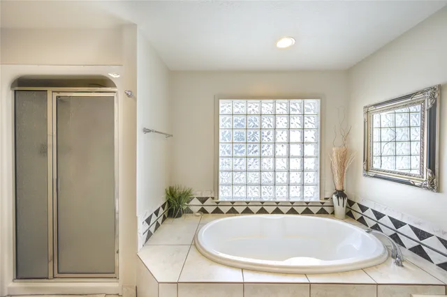 a bathroom with a tub and sink