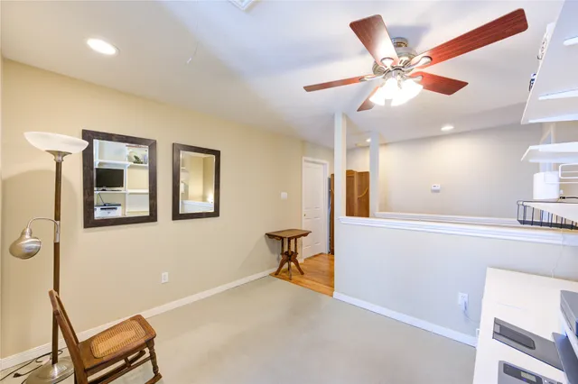 a view of a livingroom with furniture and a ceiling fan