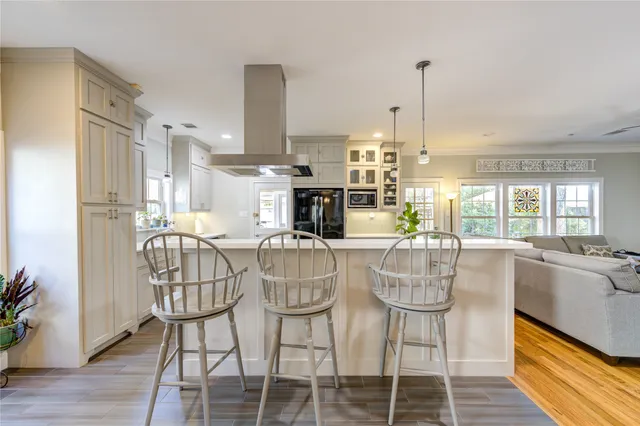 a dining room with furniture a chandelier and wooden floor