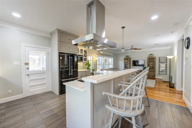 a view of a kitchen with cabinets and wooden floor