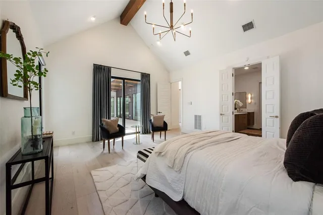 a bedroom with a bed and a chandelier