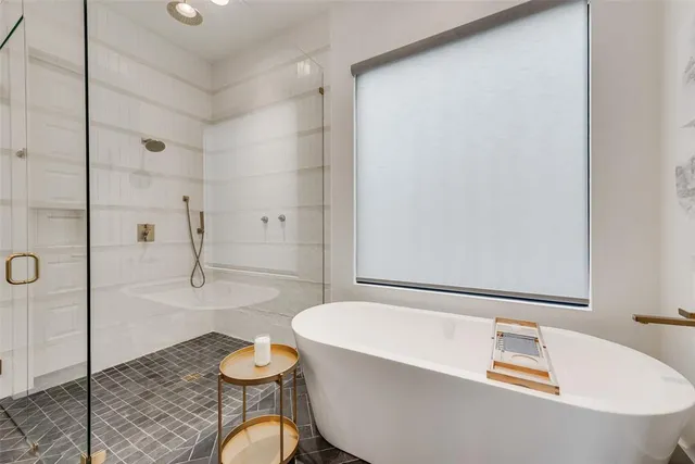 a bathroom with a tub and toilet