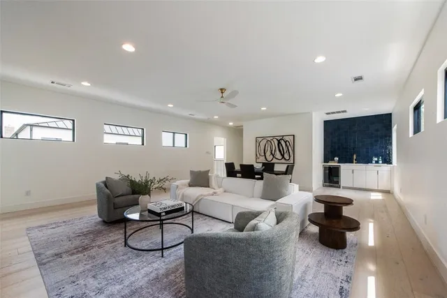 a living room with furniture and a view of kitchen