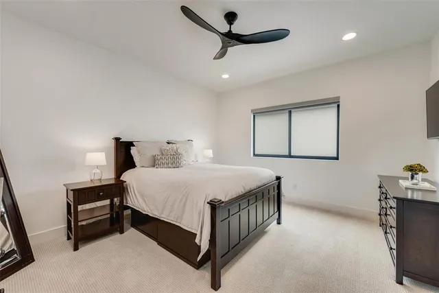 a bedroom with a bed and a ceiling fan