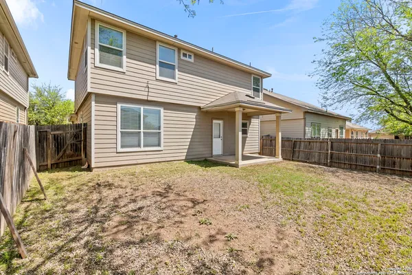 a view of a house with backyard and garden