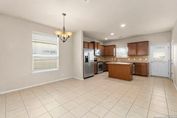 a kitchen with stainless steel appliances granite countertop a stove sink and cabinets