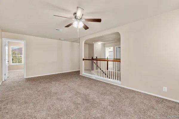 an empty room with windows and entryway