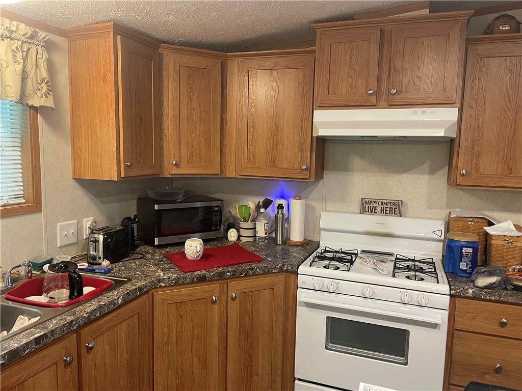 14624 Gilliland Road Linesville, PA 16424 - Photo 12 of 23 a kitchen with stove and cabinets