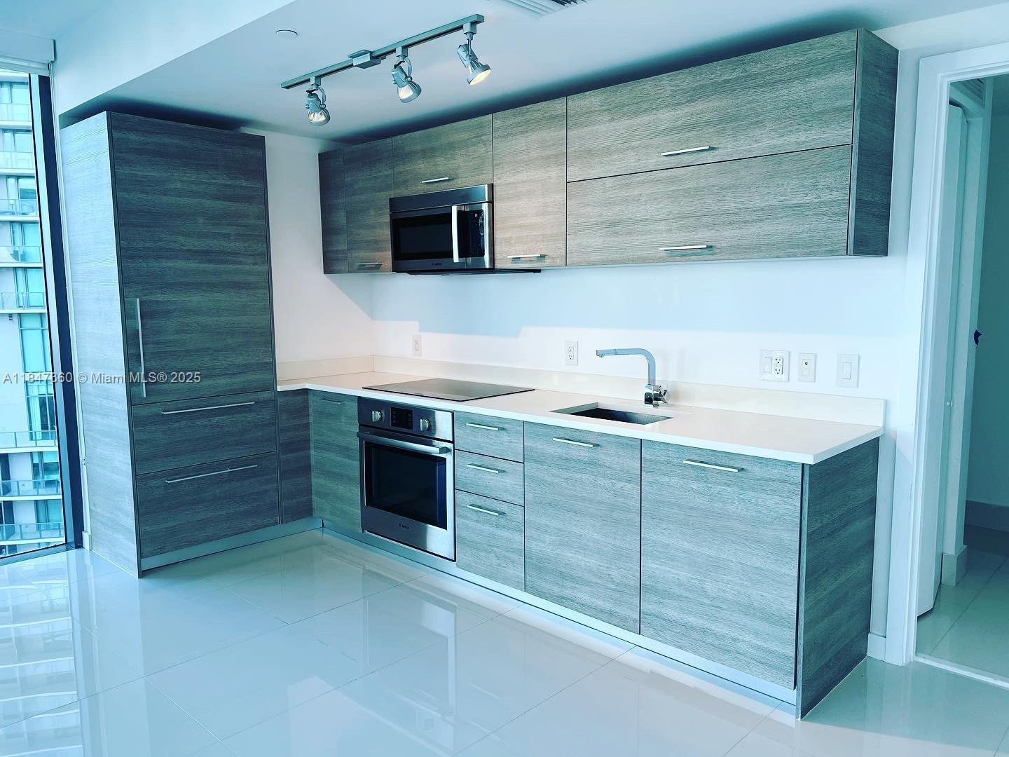 650 Northeast 32nd Street, Unit 3508 Miami, FL 33137 - Photo 5 of 13 a bathroom with a sink double vanity and a mirror