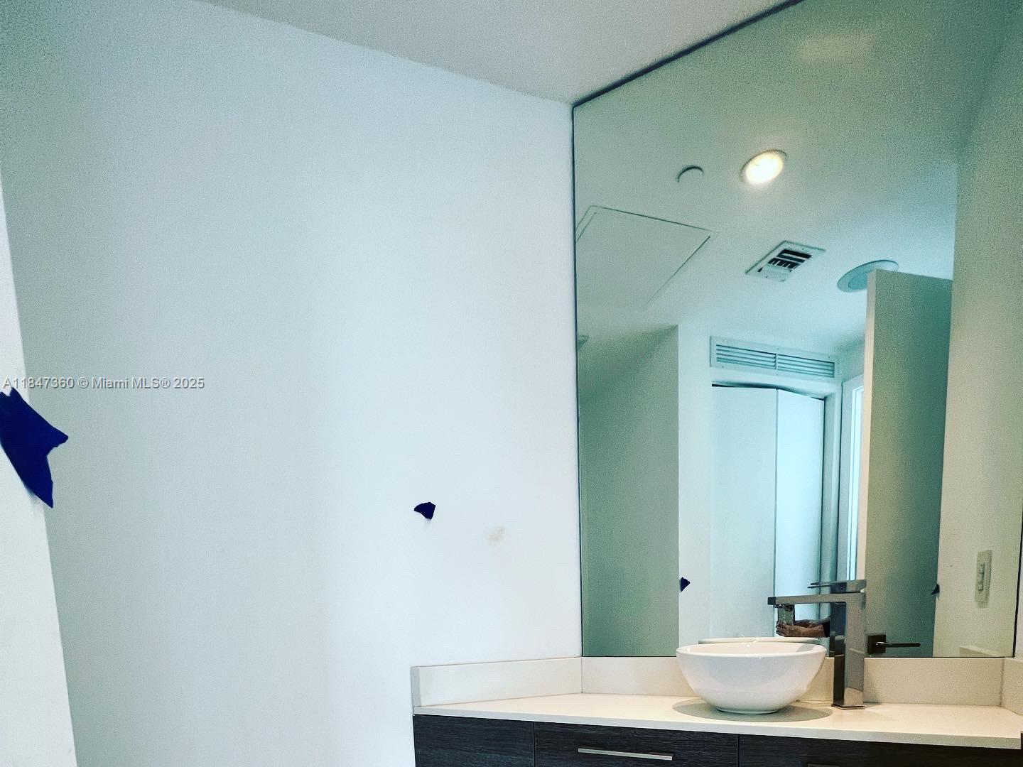 650 Northeast 32nd Street, Unit 3508 Miami, FL 33137 - Photo 7 of 13 a bathroom with a sink and a mirror