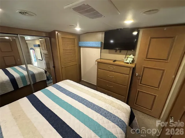 a bed room with a bed and a large window