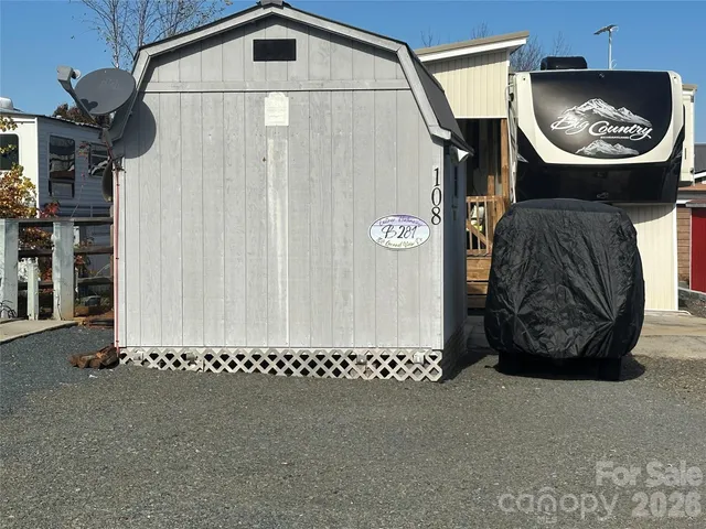 an aerial view of a house with a yard and lake view