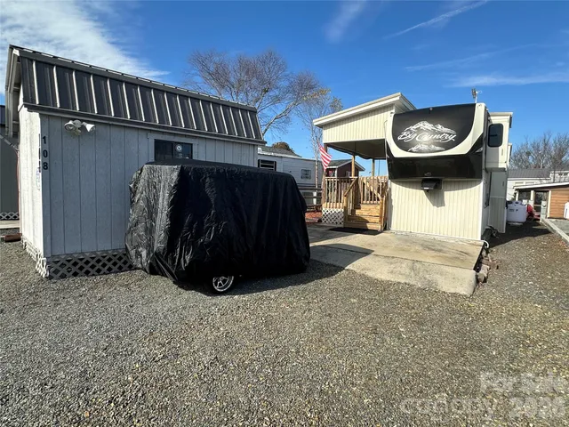 a view of a patio with a table and chairs under an umbrella