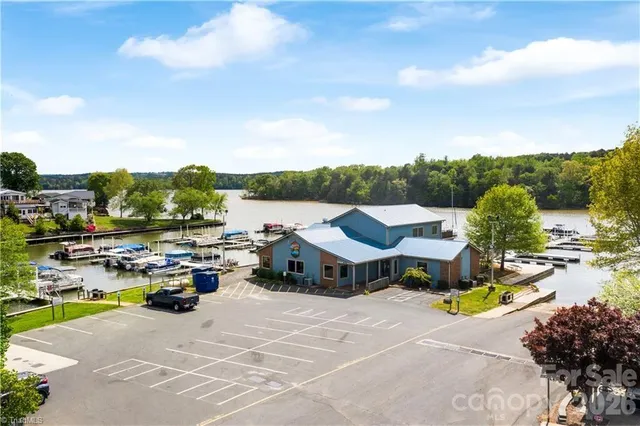 an aerial view of a house with swimming pool garden and patio