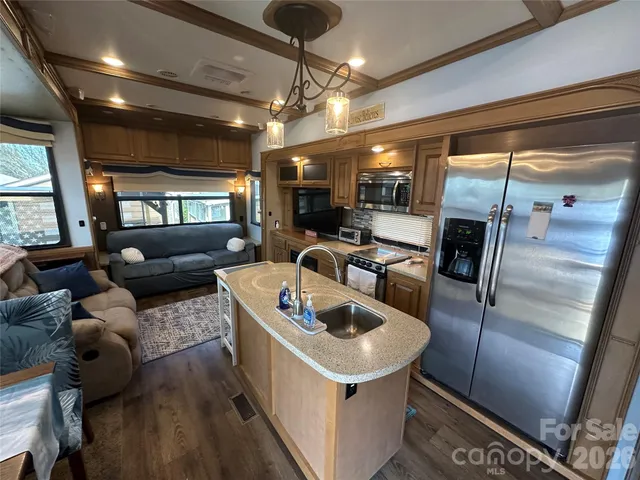 a kitchen with sink refrigerator and window