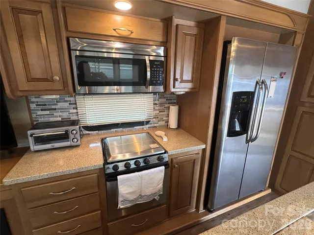 a kitchen with a stove microwave and refrigerator