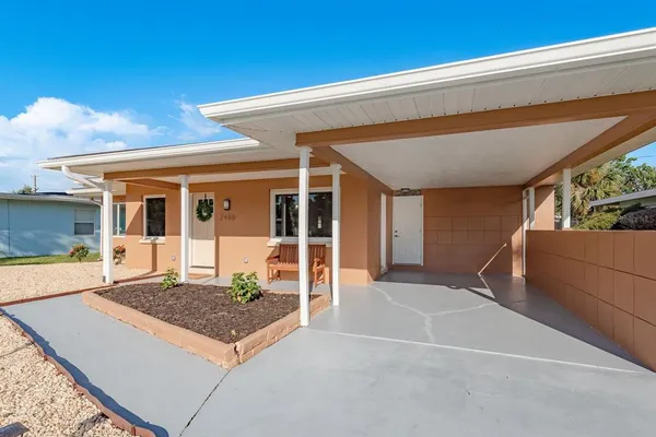 a kitchen with stainless steel appliances a sink a stove a refrigerator cabinets and wooden floor