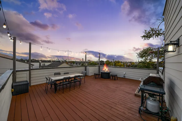 a view of a house with a small yard and wooden fence