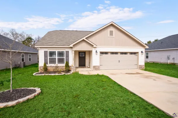 a front view of a house with a yard and garage
