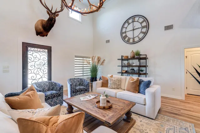 a living room with furniture a flat screen tv and a fireplace