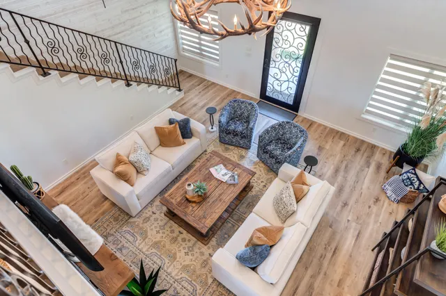 a kitchen with granite countertop white cabinets stainless steel appliances and a window