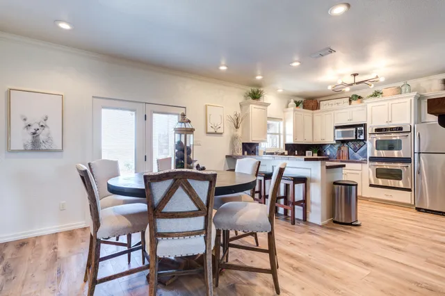 a bedroom with a large bed and a chandelier