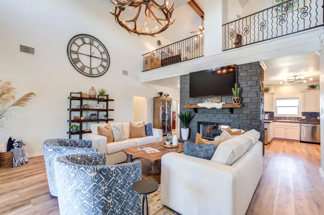 a living room with fireplace furniture and a flat screen tv