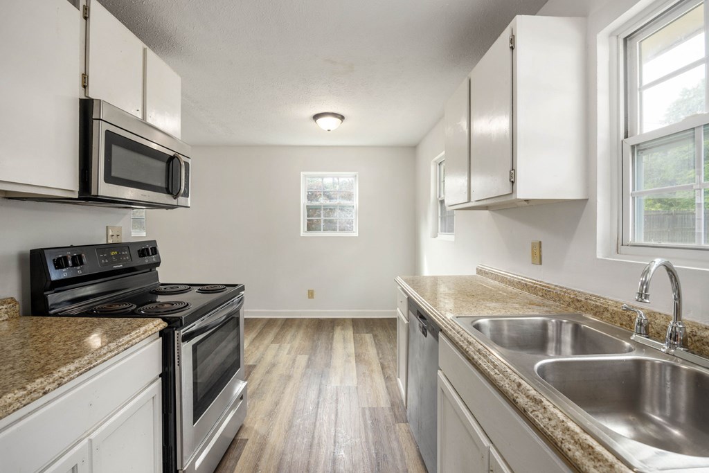 246 Sunnyside Church Road Pine Mountain, GA 31822 - Photo 8 of 26 a kitchen that has a sink wooden floor and stainless steel appliances