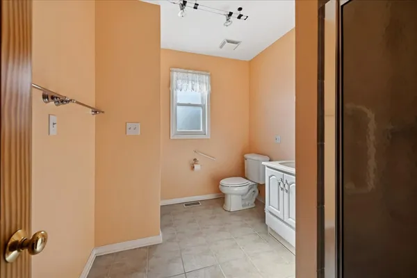 a bathroom with a toilet sink and shower