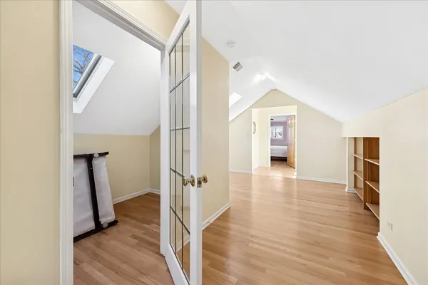 a view of a hallway view with wooden floor and staircase