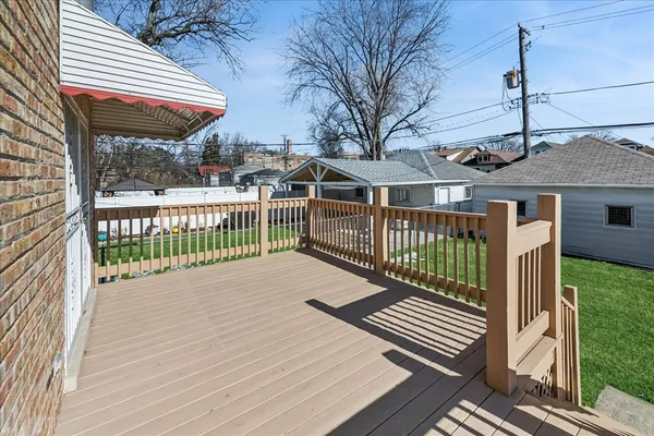 a view of a house with a wooden deck