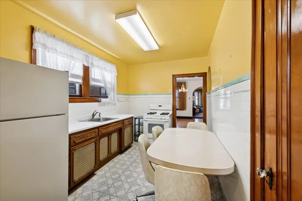 a white refrigerator freezer sitting inside of a kitchen