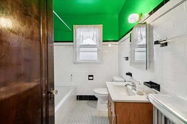 a bathroom with a sink toilet and tub