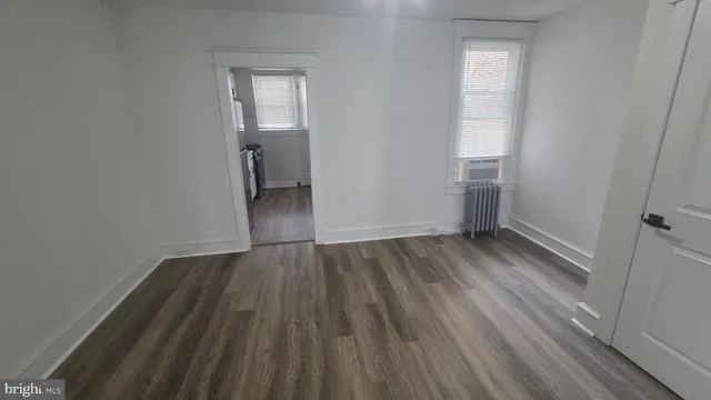 a view of a room with wooden floor and a sink