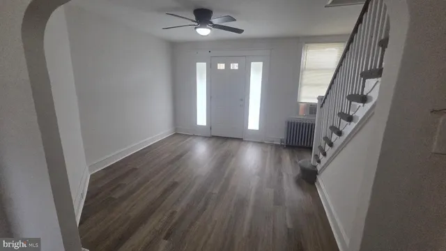 wooden floor in an empty room with a window