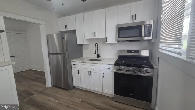 a kitchen with a stove microwave and refrigerator
