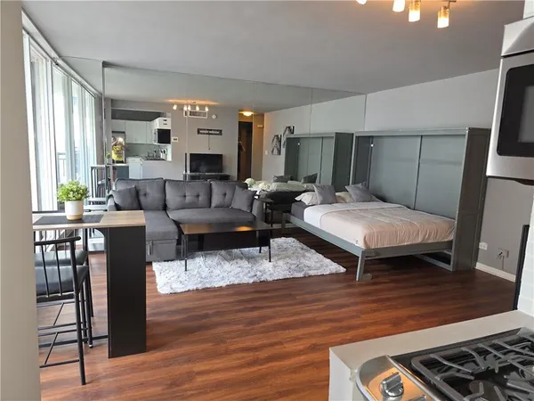 a bedroom with furniture and a wooden floor