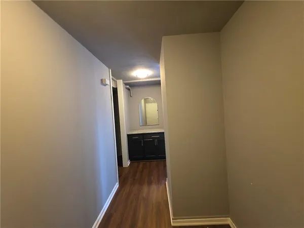 a view of a hallway with wooden floor