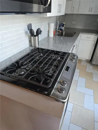a stove top oven sitting inside of a kitchen