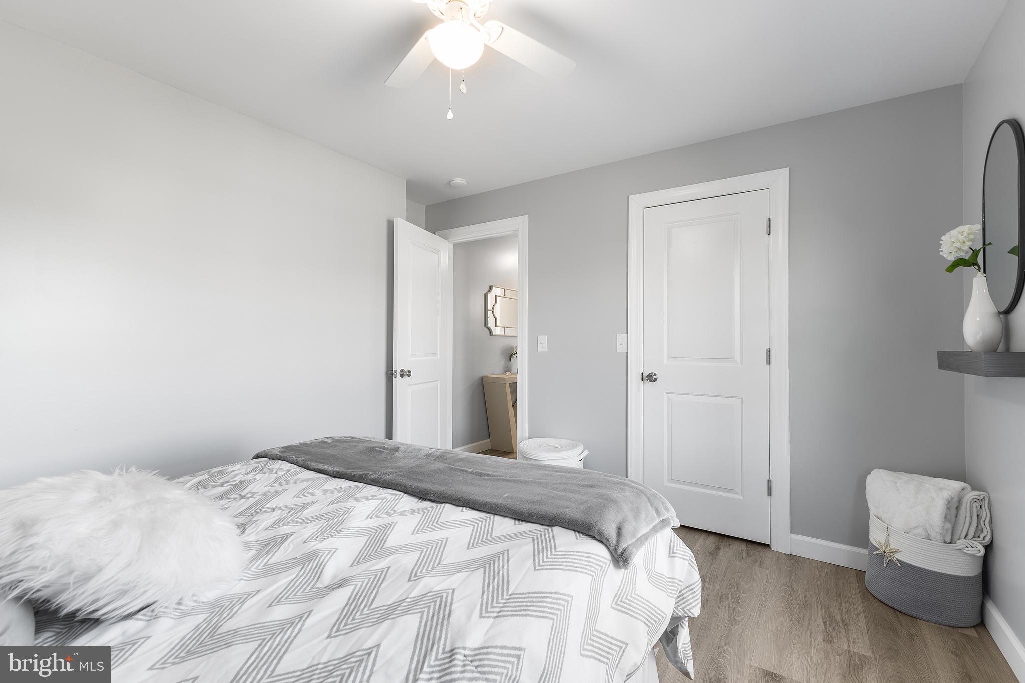 25485 Hignutt Road Denton, MD 21629 - Photo 27 of 52 a bedroom with a bed and a chandelier