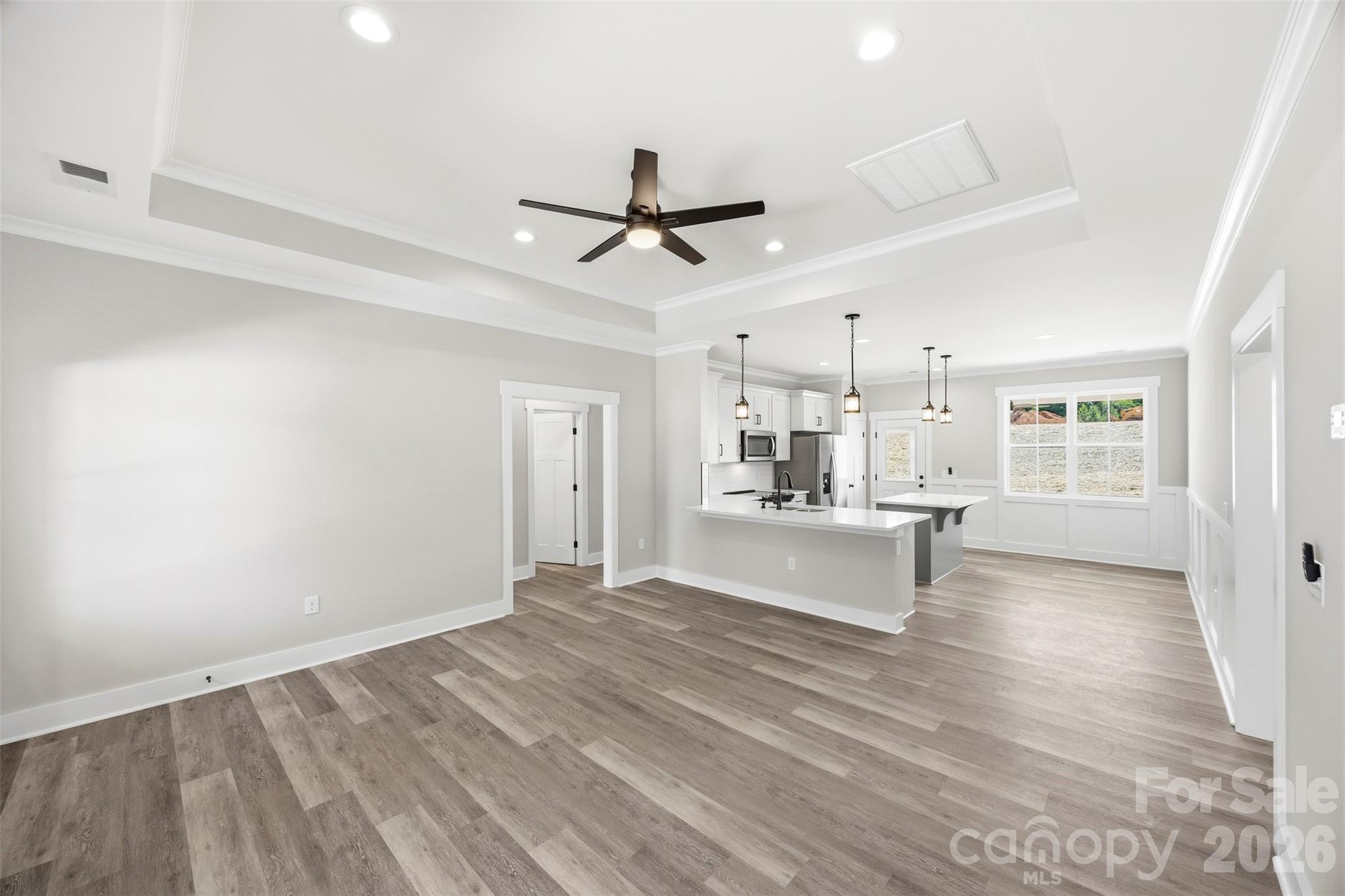 1014 Speight Road Albemarle, NC 28001 - Photo 5 of 28 a view of a kitchen with wooden floor and a ceiling fan