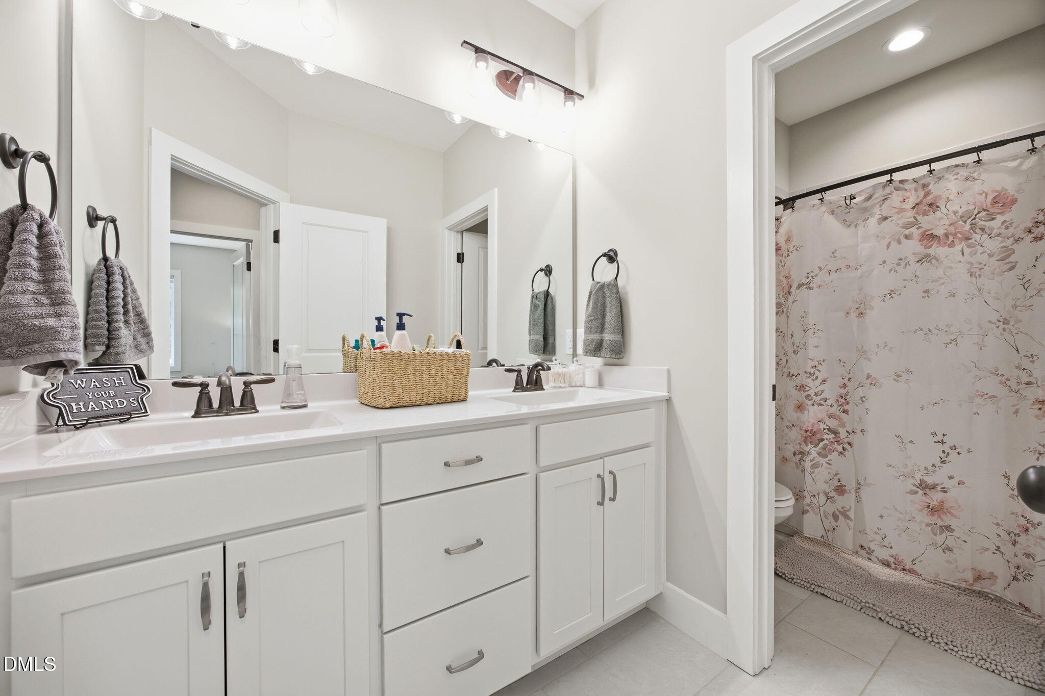 3511 Bruce Garner Road Wake Forest, NC 27587 - Photo 33 of 56 a bathroom with a double vanity sink mirror and shower