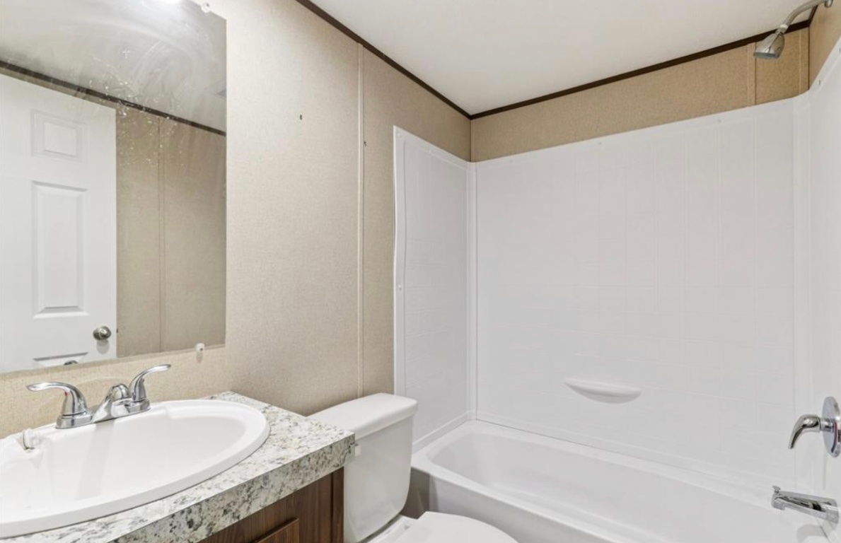 24369-2 Bingham Creek Road, Unit 1 Leander, TX 78641 - Photo 11 of 17 a bathroom with a granite countertop sink and a mirror