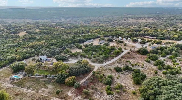a view of a big yard with lots of green space