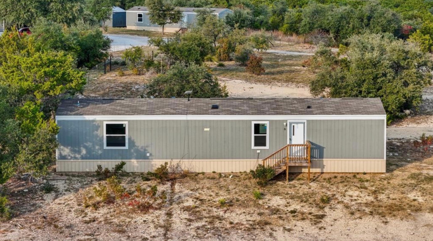 24369-2 Bingham Creek Road, Unit 1 Leander, TX 78641 - Photo 2 of 17 an aerial view of house with yard and trees in the background