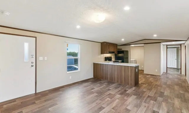 a view of a kitchen with a sink and cabinets