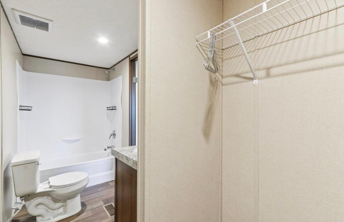 24369-2 Bingham Creek Road, Unit 1 Leander, TX 78641 - Photo 9 of 17 a bathroom with a toilet and shower