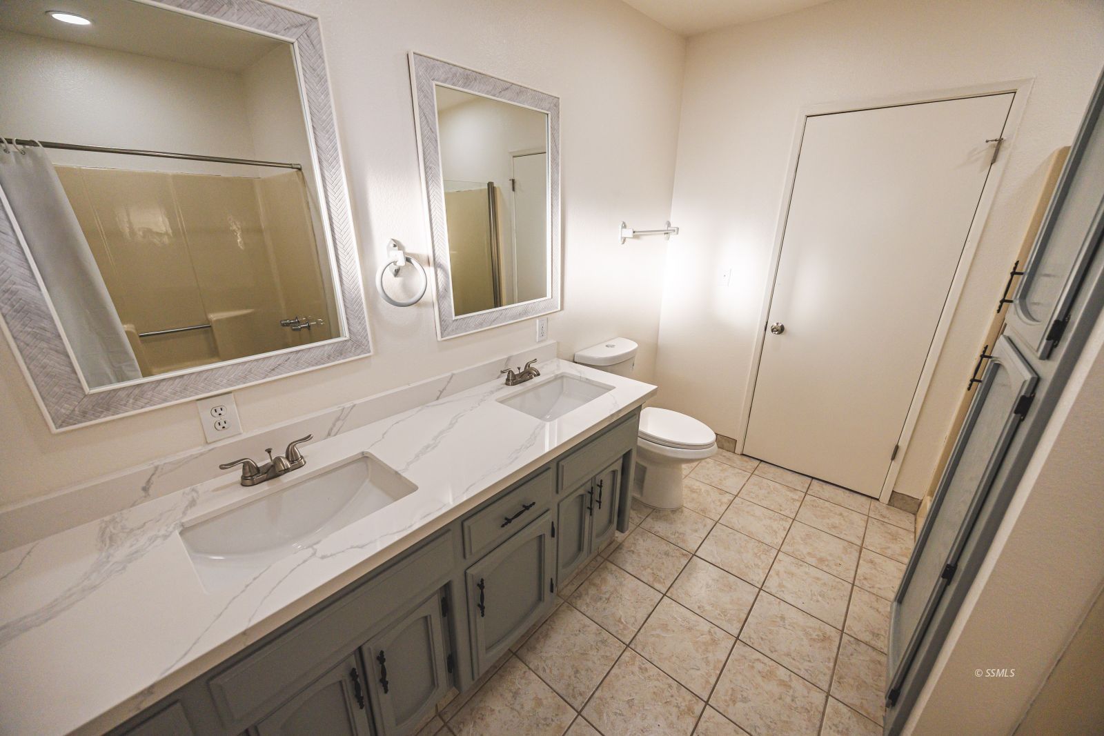 1213 Primrose Street Ridgecrest, CA 93555 - Photo 24 of 37 a spacious bathroom with a double vanity sink toilet and mirror